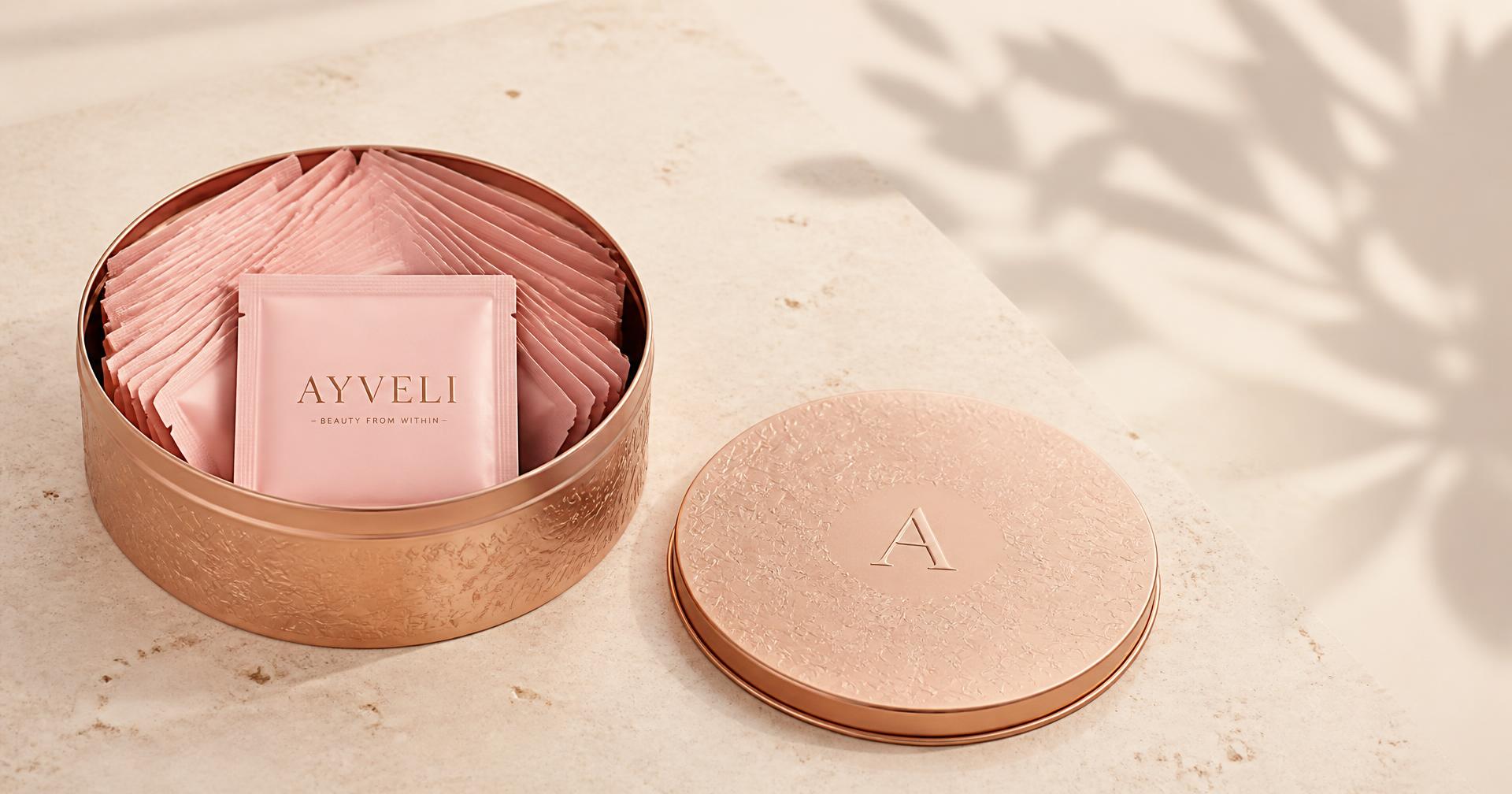Open rose-gold tin of daily AYVELI sachets with its lid resting beside it